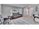 Bright living room showcasing a bay window, modern furniture and wood-look flooring at 9693 58Th N St, Pinellas Park, FL 33782