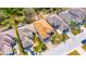 An aerial view of a single-story home with brick driveway and manicured landscaping at 1004 Regal Manor Way, Sun City Center, FL 33573