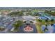 Aerial view of Sun City Center Community Hall featuring tennis courts, beautiful landscaping, and the Sun City Memorial at 1004 Regal Manor Way, Sun City Center, FL 33573