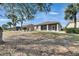 Expansive backyard featuring a screened lanai, perfect for outdoor enjoyment at 1004 Regal Manor Way, Sun City Center, FL 33573