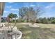 Landscaped backyard featuring ornamental trees and rock mulch at 1004 Regal Manor Way, Sun City Center, FL 33573