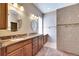 Spacious bathroom features dual sinks, granite countertops, tiled shower, and neutral wall colors at 1004 Regal Manor Way, Sun City Center, FL 33573