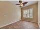 Inviting bedroom with tile flooring, ceiling fan, and bright natural light from window at 1004 Regal Manor Way, Sun City Center, FL 33573