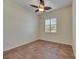 Bedroom features tile flooring, a ceiling fan, and natural light from the window at 1004 Regal Manor Way, Sun City Center, FL 33573