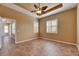 Large bedroom features neutral walls, tiled floor, tray ceiling, and plentiful natural light from shuttered windows at 1004 Regal Manor Way, Sun City Center, FL 33573