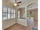 Bright breakfast nook featuring shuttered windows and decorative ceiling fan, adjacent to the tiled living area at 1004 Regal Manor Way, Sun City Center, FL 33573