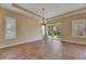 Bright dining room with tile flooring, tray ceilings, and sliding glass doors to the outdoor area at 1004 Regal Manor Way, Sun City Center, FL 33573