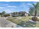 Charming single-story home with a well-manicured lawn and tropical landscaping at 1004 Regal Manor Way, Sun City Center, FL 33573