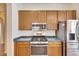 Close-up of the kitchen with stainless steel oven and microwave, and wood cabinets at 1004 Regal Manor Way, Sun City Center, FL 33573