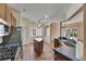 Open kitchen layout with stainless steel appliances, a center island, and access to the living area at 1004 Regal Manor Way, Sun City Center, FL 33573