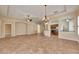 Bright, spacious living room featuring tile flooring, ceiling fans, and decorative archways at 1004 Regal Manor Way, Sun City Center, FL 33573