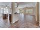 Spacious living room view, showcasing tile flooring, archways and natural light from plantation shutters at 1004 Regal Manor Way, Sun City Center, FL 33573