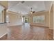 Light-filled living room with tile floors, plantation shutters, and sliding glass doors to the backyard at 1004 Regal Manor Way, Sun City Center, FL 33573