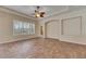 Cozy living room with tile floors, a ceiling fan, and plantation shutters on the windows at 1004 Regal Manor Way, Sun City Center, FL 33573