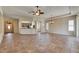 Spacious living area featuring tile floors, open access to the kitchen, and multiple windows at 1004 Regal Manor Way, Sun City Center, FL 33573