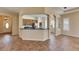 Open-concept living room and kitchen with tile floors and archways leading to additional spaces at 1004 Regal Manor Way, Sun City Center, FL 33573