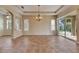 Living room with tile floors, tray ceilings, and sliding door access to the patio at 1004 Regal Manor Way, Sun City Center, FL 33573