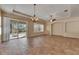 Open living room with sliding glass doors to lanai, neutral paint, and tile floors at 1004 Regal Manor Way, Sun City Center, FL 33573