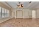 Spacious living room features tile flooring, tray ceilings, and a stylish ceiling fan at 1004 Regal Manor Way, Sun City Center, FL 33573