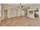 Open living area with neutral paint, tile floors, and doorway to the kitchen at 1004 Regal Manor Way, Sun City Center, FL 33573