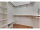 Walk-in closet features adjustable shelving, ample storage space, and a clean, organized layout at 1004 Regal Manor Way, Sun City Center, FL 33573