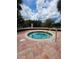 Inviting community hot tub with brick flooring and green landscaping, offering a peaceful place to relax at 10263 Gandy Blvd # 2314, St Petersburg, FL 33702