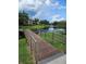 A bridge leading to a serene pond surrounded by trees, green grass, and community buildings at 10263 Gandy Blvd # 2314, St Petersburg, FL 33702