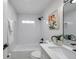 Bright bathroom featuring white tiling and quartz countertops with matte black hardware at 11005 Tyler Dr, Port Richey, FL 34668