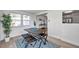 Bright dining area with pale wood flooring, rustic table set with seating, and view into the kitchen at 11005 Tyler Dr, Port Richey, FL 34668