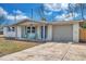 Attractive single-story home featuring a well-maintained lawn, a driveway, and a welcoming front porch at 11005 Tyler Dr, Port Richey, FL 34668