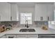 Close-up of updated kitchen sink with stainless steel appliances, and modern countertops at 11005 Tyler Dr, Port Richey, FL 34668