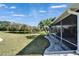 Backyard view of screened patio, lush lawn and a serene pond at 1228 Caloosa Creek Ct, Sun City Center, FL 33573