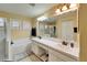 Bathroom featuring double sinks, bathtub, and walk-in shower at 1228 Caloosa Creek Ct, Sun City Center, FL 33573