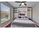 Bedroom featuring ceiling fan, wood floors, and built-in shelving unit at 1228 Caloosa Creek Ct, Sun City Center, FL 33573