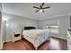 Bedroom featuring dark wood floors, neutral colors, and a large window at 1228 Caloosa Creek Ct, Sun City Center, FL 33573