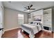 Bedroom with ceiling fan, wood floors, and custom built-in shelves at 1228 Caloosa Creek Ct, Sun City Center, FL 33573