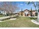 Attractive single-Gathering home with manicured lawn, stone accents, and a paved driveway at 1228 Caloosa Creek Ct, Sun City Center, FL 33573