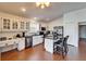 Bright kitchen with white cabinetry, stainless steel appliances, and a center island with barstools at 1228 Caloosa Creek Ct, Sun City Center, FL 33573