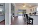 Kitchen island featuring bar stool seating with a view of an open living space and outdoor patio at 1228 Caloosa Creek Ct, Sun City Center, FL 33573