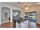 Kitchen island with black countertop and seating, open to the living area and outdoor patio at 1228 Caloosa Creek Ct, Sun City Center, FL 33573