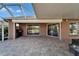 Rear covered patio with outdoor kitchen, screened ceiling and tile floors at 1228 Caloosa Creek Ct, Sun City Center, FL 33573