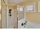 Walk-in shower featuring white subway tile, bronze fixtures, and a window at 1228 Caloosa Creek Ct, Sun City Center, FL 33573