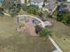 Aerial view of a playground with a picnic area and walking paths in a well-maintained community at 13351 Crest Lake Dr, Hudson, FL 34669