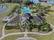 Aerial view of community center, pool, walking path, and landscaping in a scenic setting at 13351 Crest Lake Dr, Hudson, FL 34669