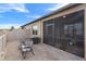 Brick paved backyard patio with outdoor seating, leading to the screened-in porch of a house at 13351 Crest Lake Dr, Hudson, FL 34669