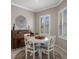 Cozy dining room with a round table, elegant decor, and natural light from shuttered windows at 13351 Crest Lake Dr, Hudson, FL 34669