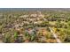 Aerial view of a wooded neighborhood with scattered homes surrounded by trees at 13386 Taylor St, Brooksville, FL 34613