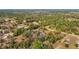 Aerial view of a property nestled among lush greenery and tall trees along road, offering privacy at 13386 Taylor St, Brooksville, FL 34613