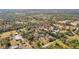 Aerial view of a wooded property with several white buildings, showcasing its expansive and private setting at 13386 Taylor St, Brooksville, FL 34613