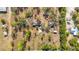 Overhead view of a property with a house, overgrown landscape, and long driveway, showcasing the land's layout at 13386 Taylor St, Brooksville, FL 34613